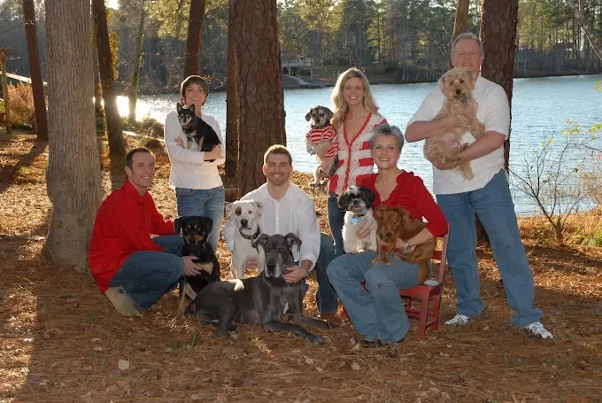 The Waggin' Wagon family gathered outdoors with their dogs